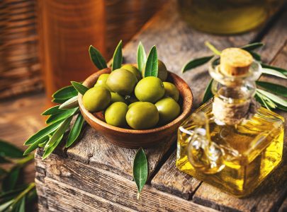 Image of olives and olive oil in rustic style, still life