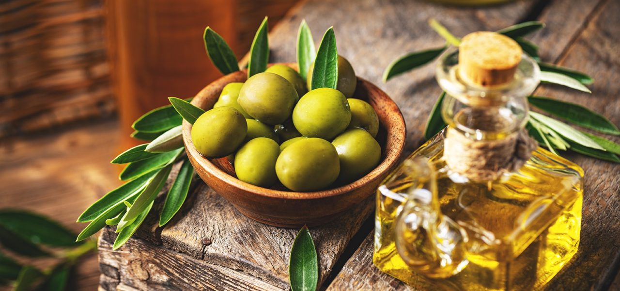 Image of olives and olive oil in rustic style, still life