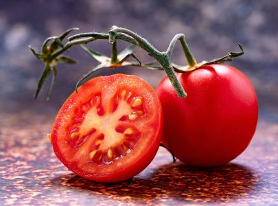 A ripe red tomato on a flat surface