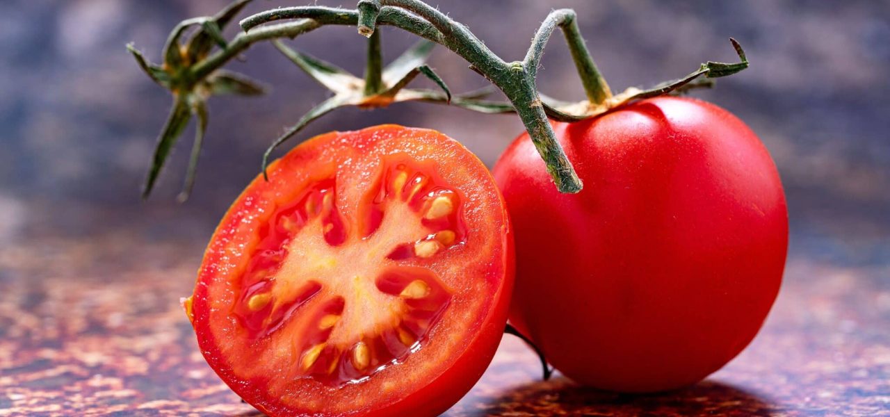 A ripe red tomato on a flat surface