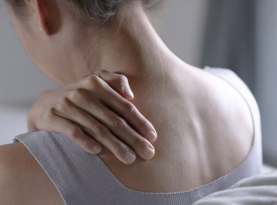 Asian woman has shoulder pain. Female holding painful shoulder with another hand. People with body-muscles problem, Healthcare And Medicine.