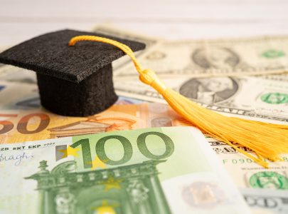 Graduation gap hat on US dollar banknotes money, Education study fee learning teach concept.